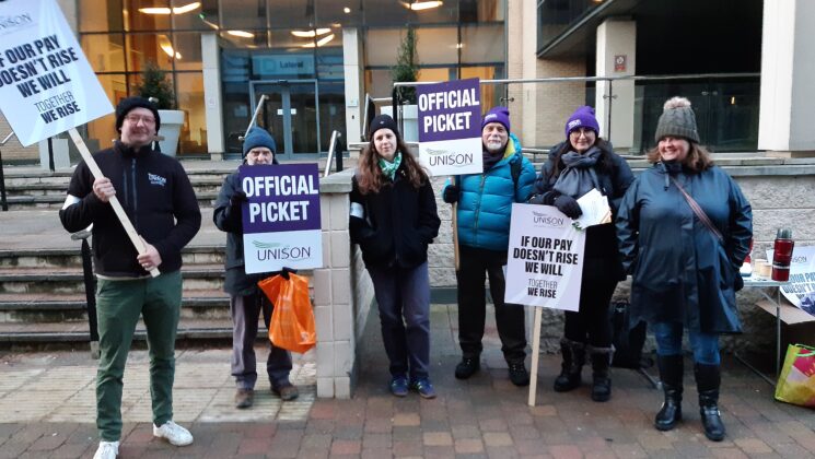 Environment Agency picket line in Leeds. Striking workers hold flags and placards